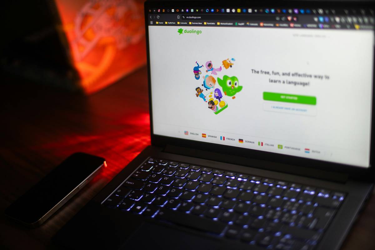 Person using multiple language apps including duolingo to learn easy spanish with duolingo alongside native speaker practice